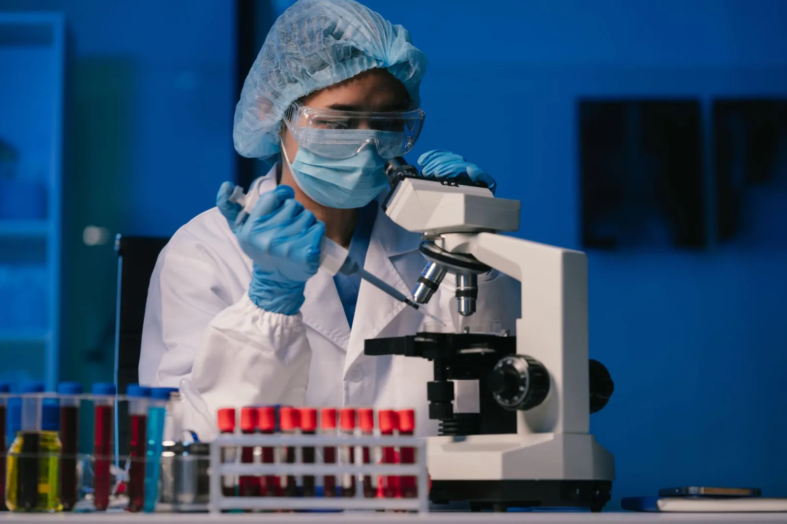 Laboratory researcher examining a sample under a microscope