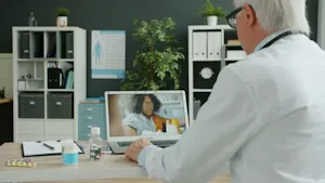 Physician consulting a patient remotely through telehealth video call