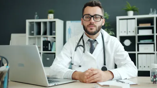 Portrait of a cardiology editorial board reviewer in a white coat